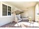 Inviting porch includes a porch swing, modern seating, and view to the neighborhood at 3732 Via Gennaro, Henderson, NV 89044