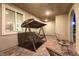 Evening view of the porch showcasing the porch swing, modern seating, and cozy lighting at 3732 Via Gennaro, Henderson, NV 89044