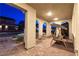 Evening view of the arched front porch showcasing porch swing and stylish seating at 3732 Via Gennaro, Henderson, NV 89044