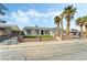 Charming single-story home with a well-manicured lawn and palm trees at 436 Bell Ave, Henderson, NV 89015