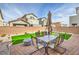 Private backyard with outdoor dining set and artificial grass at 4364 Contour Bend Ave, North Las Vegas, NV 89084