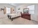 Cozy bedroom with carpet floors, two bright windows, and a classic dark wood dresser at 4364 Contour Bend Ave, North Las Vegas, NV 89084
