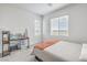Well-lit bedroom featuring carpet floors, neutral walls, two windows, and built-in shelving at 4364 Contour Bend Ave, North Las Vegas, NV 89084