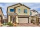 Two-story home with a tan exterior, a two-car garage, and desert landscaping at 4364 Contour Bend Ave, North Las Vegas, NV 89084