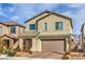 Charming two-story home with a tan exterior, a two-car garage, and low maintenance landscaping at 4364 Contour Bend Ave, North Las Vegas, NV 89084