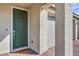 Inviting home exterior featuring a green front door, brick pathway, and textured pillars leading to the garage at 4364 Contour Bend Ave, North Las Vegas, NV 89084