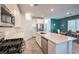 Bright kitchen with white cabinets, stainless steel appliances, a large island, and a dining nook at 4364 Contour Bend Ave, North Las Vegas, NV 89084