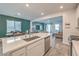 Open-concept kitchen featuring a large island, stainless steel appliances, and a view of the living space at 4364 Contour Bend Ave, North Las Vegas, NV 89084