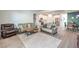Open-concept living space with couches and a dining area adjacent to the kitchen with stainless steel appliances at 4364 Contour Bend Ave, North Las Vegas, NV 89084