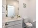 Well-lit powder room featuring a modern vanity, mirror, and toilet at 4364 Contour Bend Ave, North Las Vegas, NV 89084
