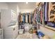Walk-in closet with washer and dryer, rod space and shelving for storage and organization at 4364 Contour Bend Ave, North Las Vegas, NV 89084