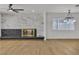 Spacious living room featuring a modern fireplace with marble accent wall, wood floors, and contemporary lighting at 4578 Ridgedale Ave, Las Vegas, NV 89121