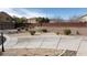 Desert landscaped backyard with a long driveway, a block wall, and an outdoor light post at 4798 Luna Ridge Ct, Las Vegas, NV 89129