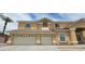 Charming two-story home with a three-car garage, tan stucco exterior, and tile roof at 4798 Luna Ridge Ct, Las Vegas, NV 89129
