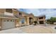 Inviting two-story home with a tan stucco exterior, low maintenance landscaping, and an attached two-car garage at 4798 Luna Ridge Ct, Las Vegas, NV 89129