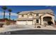 Two-story home with a three-car garage and desert landscaping under a clear blue sky at 4798 Luna Ridge Ct, Las Vegas, NV 89129