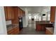 Kitchen area featuring granite countertops, wood cabinets, black appliances, and an open floor plan at 4798 Luna Ridge Ct, Las Vegas, NV 89129