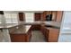 Kitchen area featuring granite countertops, wood cabinets, and gas range at 4798 Luna Ridge Ct, Las Vegas, NV 89129