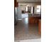 Kitchen area with tile flooring and stainless steel appliances leading to the living room with a fireplace at 4798 Luna Ridge Ct, Las Vegas, NV 89129