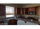 Bright kitchen with granite countertops, custom wood cabinets, and a view of the sink at 4798 Luna Ridge Ct, Las Vegas, NV 89129