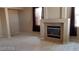 Spacious living room featuring a fireplace and neutral-toned walls and carpet, perfect for relaxation at 4798 Luna Ridge Ct, Las Vegas, NV 89129