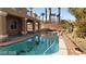 Backyard with a private pool, spa, covered patio, and desert landscaping at 4798 Luna Ridge Ct, Las Vegas, NV 89129