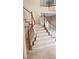 Staircase with wooden handrail and white spindles leading to the upper level at 4798 Luna Ridge Ct, Las Vegas, NV 89129