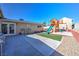 Spacious backyard with a patio, playset, and artificial turf for outdoor enjoyment at 524 8Th St, Boulder City, NV 89005