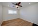 Bright bedroom features hardwood floors, a ceiling fan, and a sun-filled window at 524 8Th St, Boulder City, NV 89005