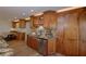 Kitchen featuring custom cabinets, granite countertops, and a stainless steel dishwasher at 524 8Th St, Boulder City, NV 89005
