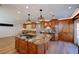 Spacious kitchen island with cooktop, wood cabinets, and stainless steel appliances at 524 8Th St, Boulder City, NV 89005