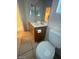 Bathroom with single sink, toilet, tile floor, and dual mirrors at 5413 Bristol Bend Ct, Las Vegas, NV 89135