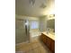 This bathroom features a vanity sink, tiled flooring, a soaking tub, and a glass shower at 5413 Bristol Bend Ct, Las Vegas, NV 89135