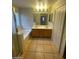 Bathroom features a double sink vanity, tub and shower combo with tiled floors at 5413 Bristol Bend Ct, Las Vegas, NV 89135