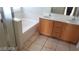 This bathroom features a vanity sink, tiled flooring, a soaking tub, and a glass shower at 5413 Bristol Bend Ct, Las Vegas, NV 89135