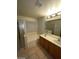 This bathroom features a vanity sink, tiled flooring, a soaking tub, and a glass shower at 5413 Bristol Bend Ct, Las Vegas, NV 89135