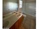 Bathroom showcasing a large mirror over the vanity and a tub with tile flooring at 5413 Bristol Bend Ct, Las Vegas, NV 89135