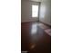 Bedroom with wood flooring and sunlight streaming through the window at 5413 Bristol Bend Ct, Las Vegas, NV 89135