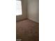 Neutral carpeted bedroom with a window providing natural light and electrical outlets on the wall at 5413 Bristol Bend Ct, Las Vegas, NV 89135