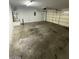 Spacious garage with an electric door and room for parking, storage, and projects at 5413 Bristol Bend Ct, Las Vegas, NV 89135