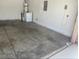 Garage showcasing a water heater, laundry machine, and plenty of open area with a concrete floor at 5413 Bristol Bend Ct, Las Vegas, NV 89135