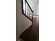 Stairwell and hallway with hardwood flooring and a dark railing at 5413 Bristol Bend Ct, Las Vegas, NV 89135
