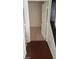 Hallway view with neutral carpet leading to an open white door at 5413 Bristol Bend Ct, Las Vegas, NV 89135