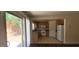 Sunny kitchen with wood cabinets, tile floors, and a view to the backyard through sliding doors at 5413 Bristol Bend Ct, Las Vegas, NV 89135