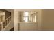 Bright, open living area featuring stairs and a large pass-through to another room at 5413 Bristol Bend Ct, Las Vegas, NV 89135