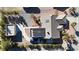 An aerial view of a home featuring solar panels, a detached garage, desert landscaping, and a long driveway at 5841 Doubletree Rd, Pahrump, NV 89061