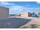 Expansive backyard with gravel landscaping, a detached structure, RV parking, and potential for customization at 5841 Doubletree Rd, Pahrump, NV 89061