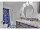 Well-lit bathroom featuring a vanity with granite counters, an oval mirror, and a shower with a curtain at 5841 Doubletree Rd, Pahrump, NV 89061