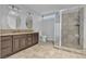 Well-lit bathroom with double sinks, granite countertops, and a glass-enclosed shower at 5841 Doubletree Rd, Pahrump, NV 89061