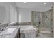 Well-lit bathroom showcasing large soaking tub and walk-in shower at 5841 Doubletree Rd, Pahrump, NV 89061